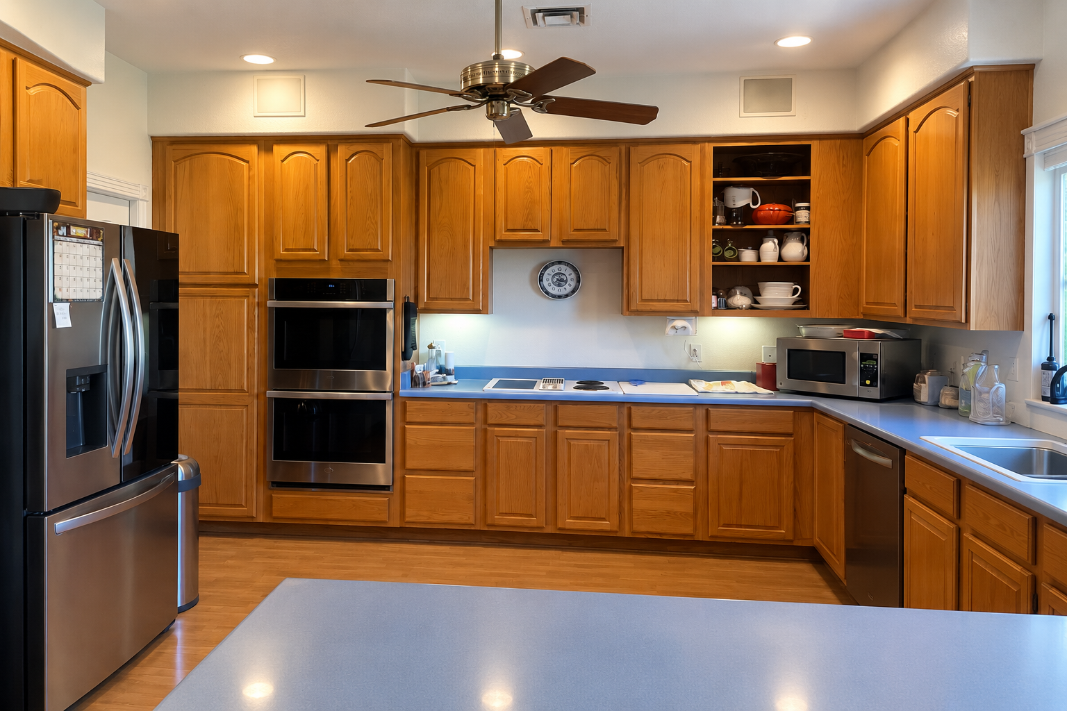 Dated golden oak kitchen cabinetry before the remodel