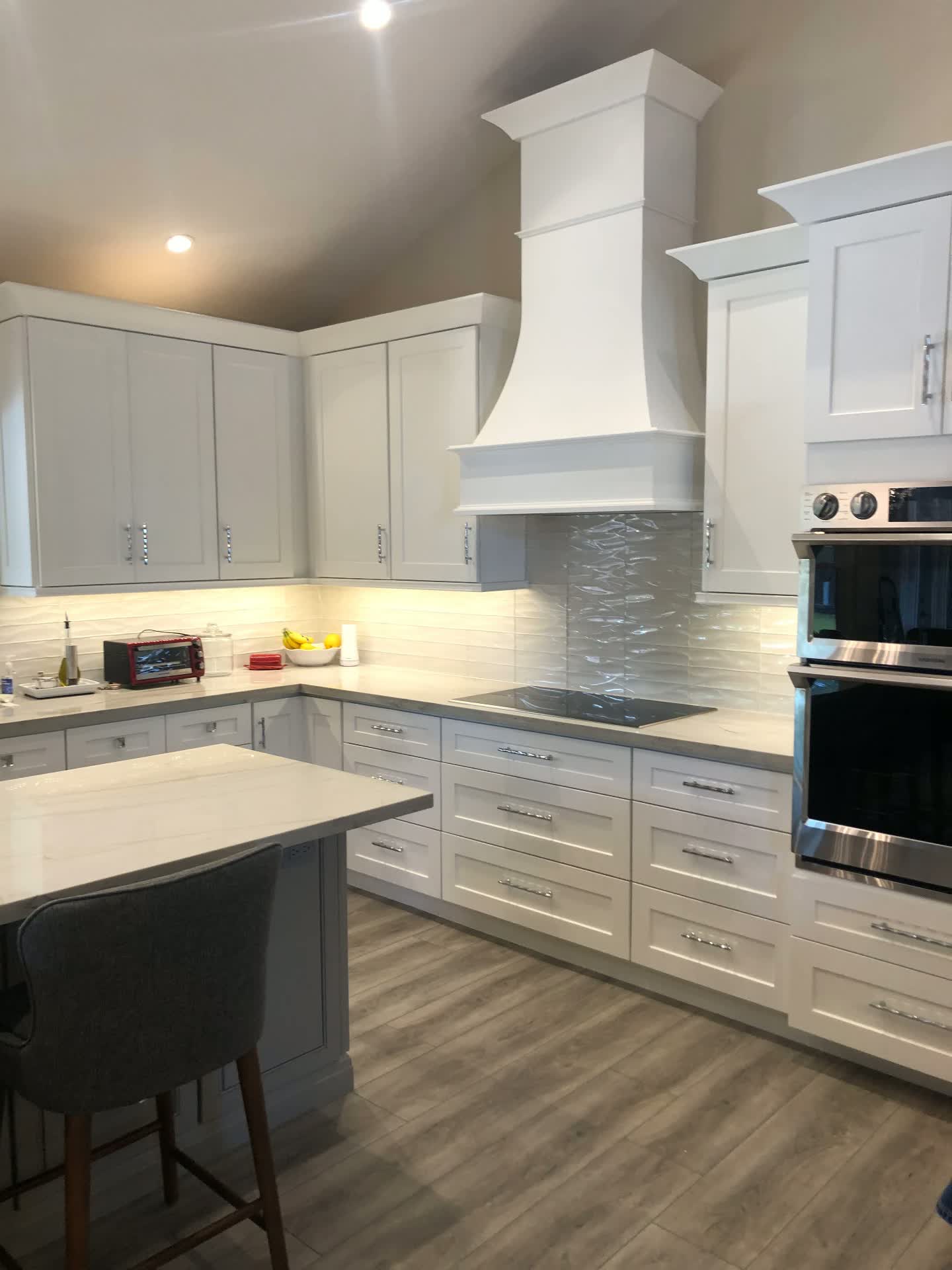 White shaker kitchen with custom wood hood surround