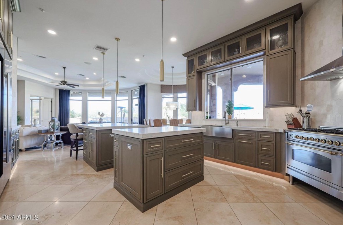Glass front upper cabinets framing a professional range